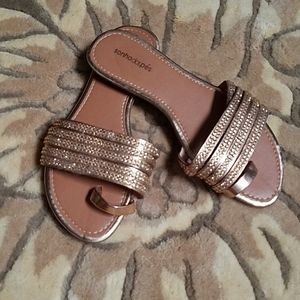 Rose gold strappy flats.